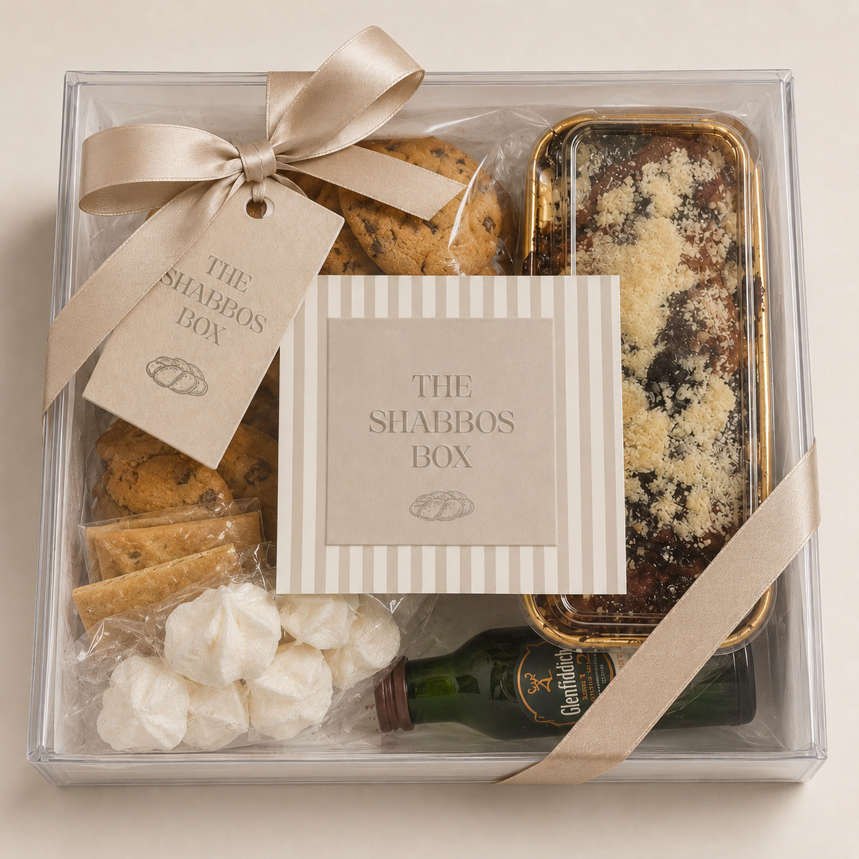 A luxury Shabbos gift box with challah, candles, wine, and babka