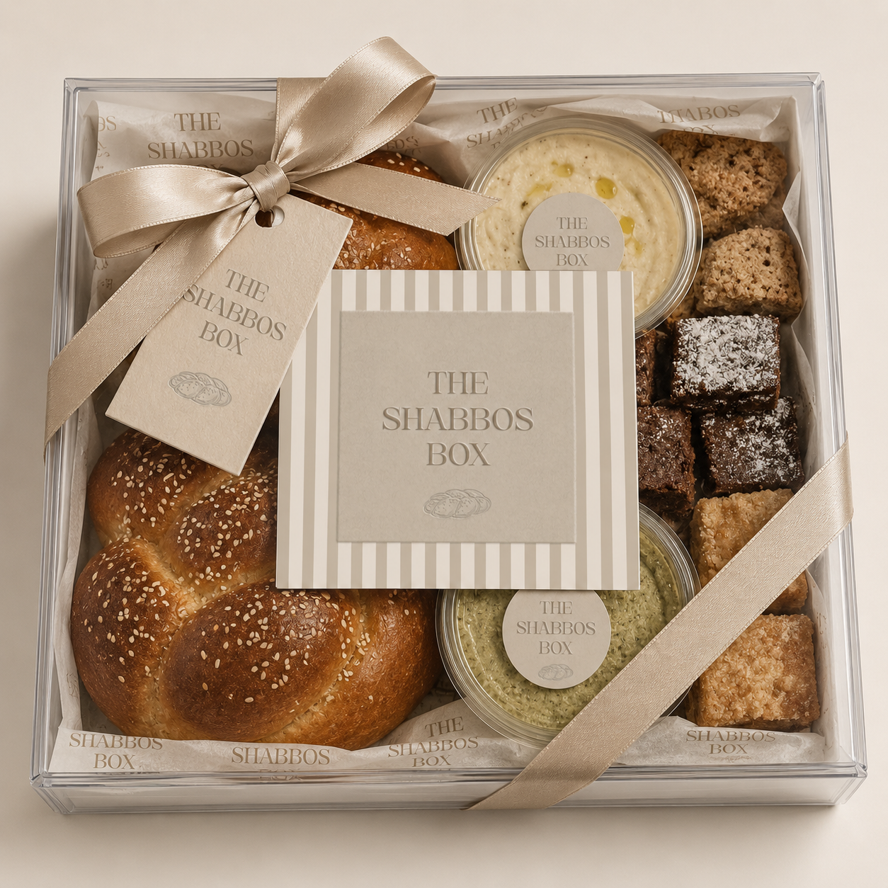 A luxury Shabbos gift box with challah, candles, wine, and babka